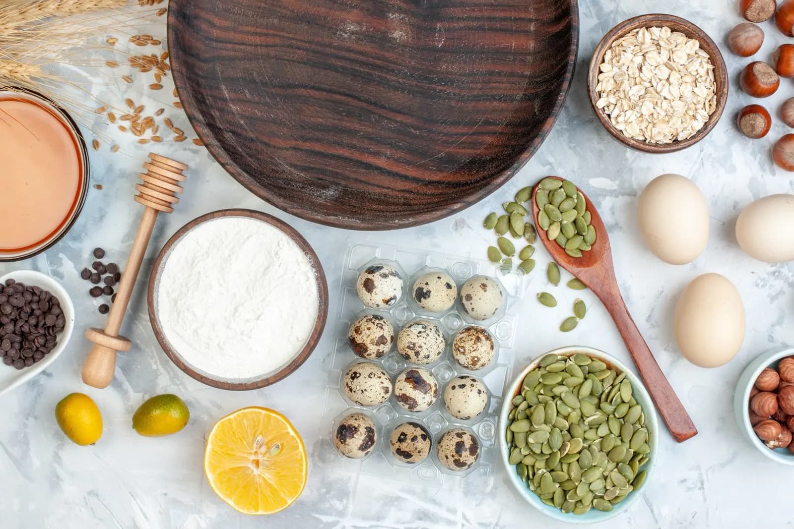 Overhead flatlay of biotin-rich foods: eggs, pumpkin seeds, oats and nuts
